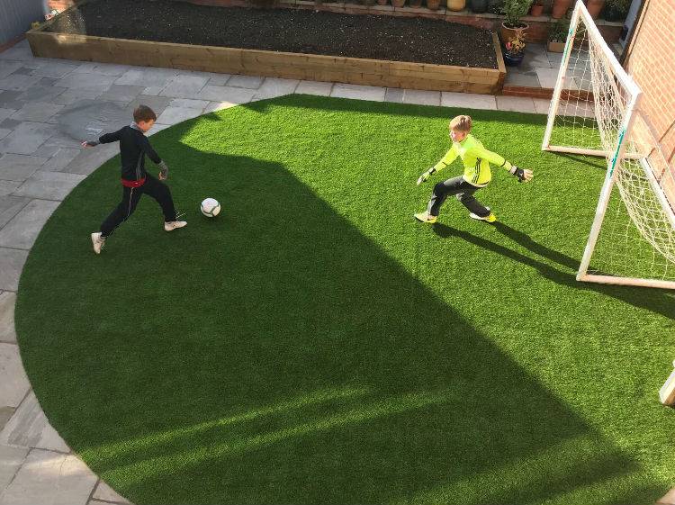 Boys playing football on artificial grass